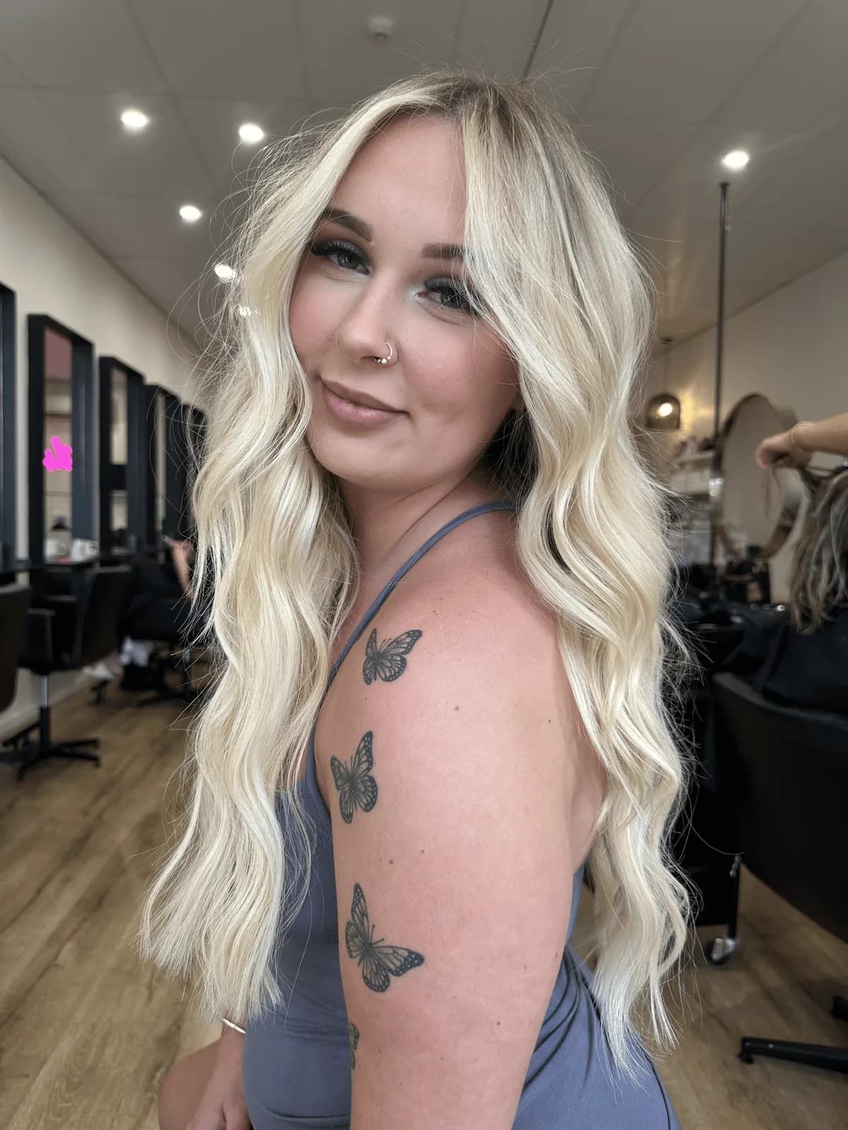 Platinum blonde weft extensions styled in soft waves
